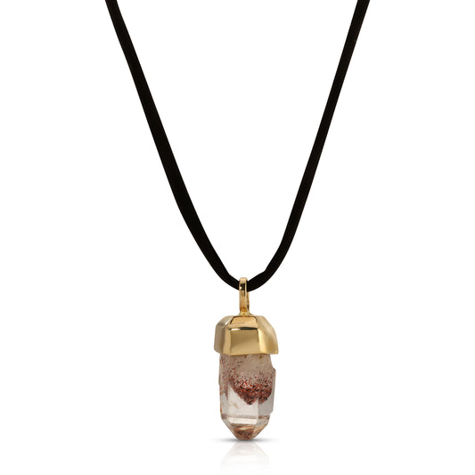 Close-up of a 14K gold-capped Harlequin Quartz crystal pendant on a black silk cord.