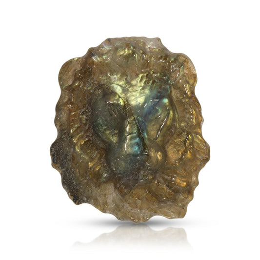 Carved Lion Labradorite stone with a reflective surface on a white background