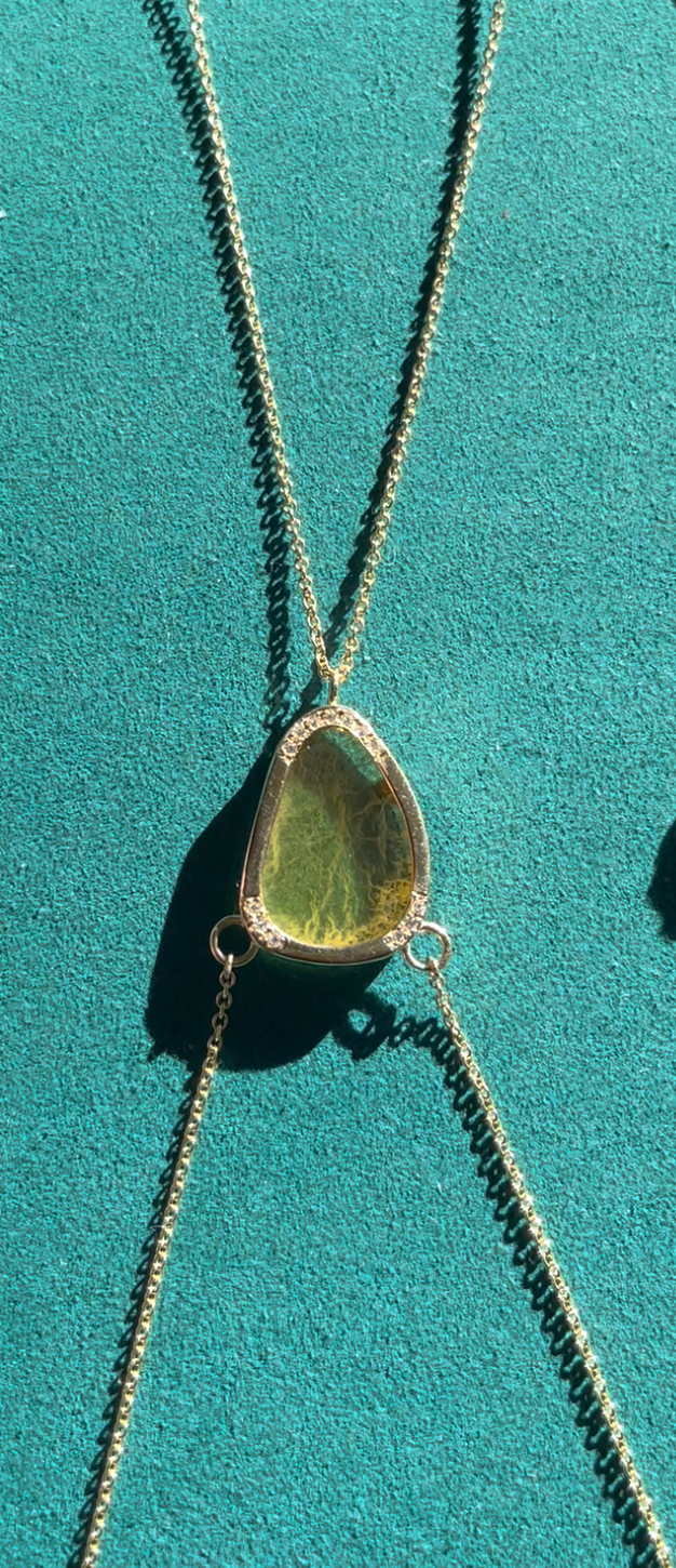 Close-up of 14K gold body chain featuring a polished yellow fluorite center stone surrounded by 1.5 ct white diamonds, handmade in Los Angeles.